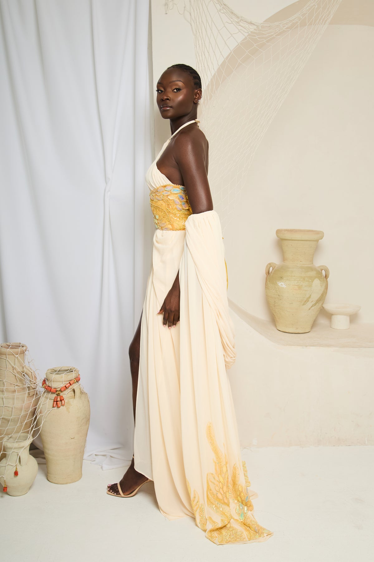 Erema - Ivory Cape Gown with Gold Waist Detail - Batch 02 Pre-Order Twin By Tare Isaac Erema - Ivory Cape Gown with Gold Waist Detail - Batch 02 Pre-Order Twin By Tare Isaac