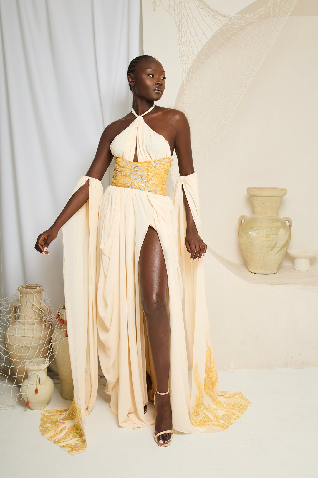 Erema - Ivory Cape Gown with Gold Waist Detail - Batch 02 Pre-Order Twin By Tare Isaac Erema - Ivory Cape Gown with Gold Waist Detail - Batch 02 Pre-Order Twin By Tare Isaac
